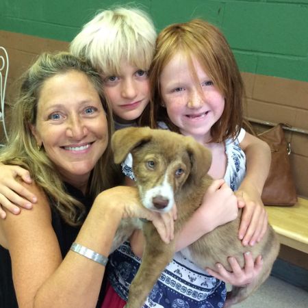 Marcy Falco and her mother took a picture with a dog.